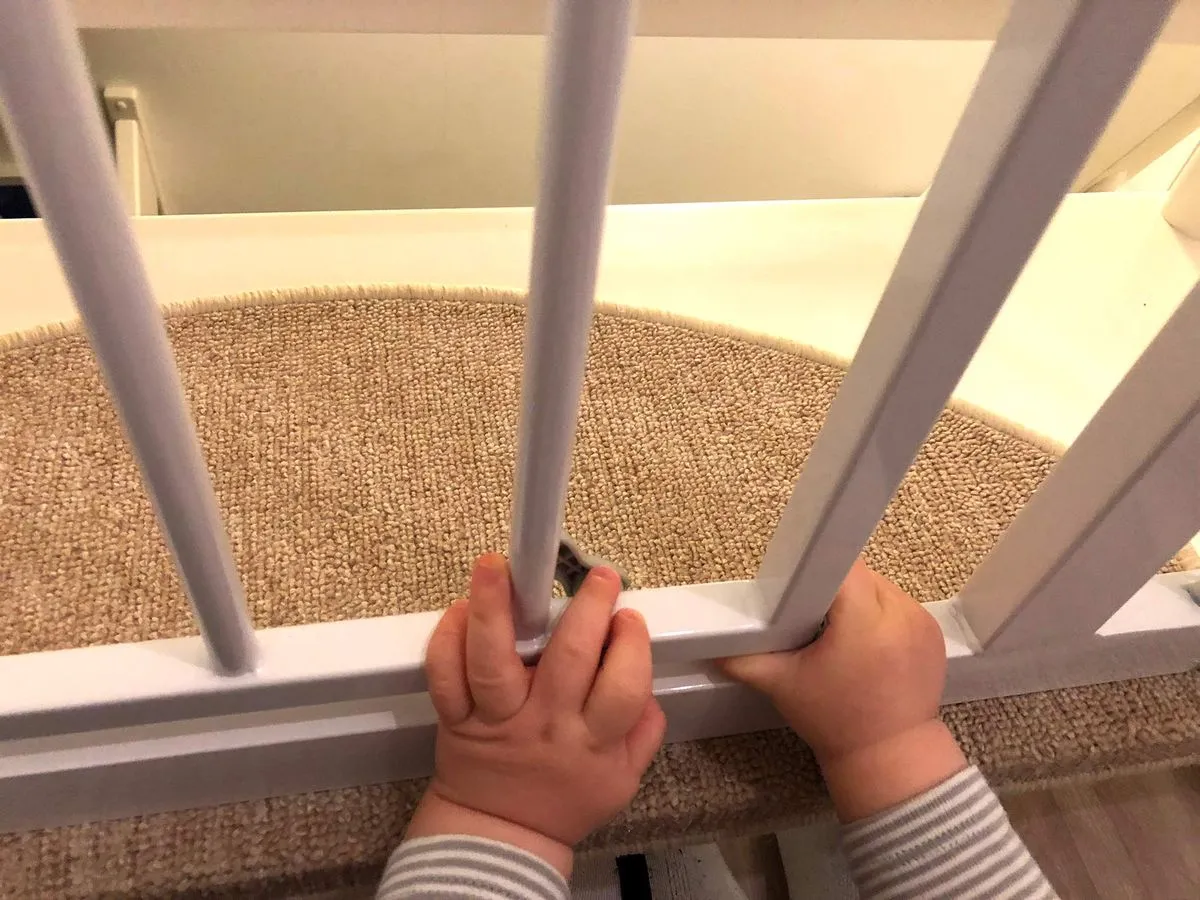 Unser Sohn begutachtet das Treppenschutzgitter von Trixie intensiv